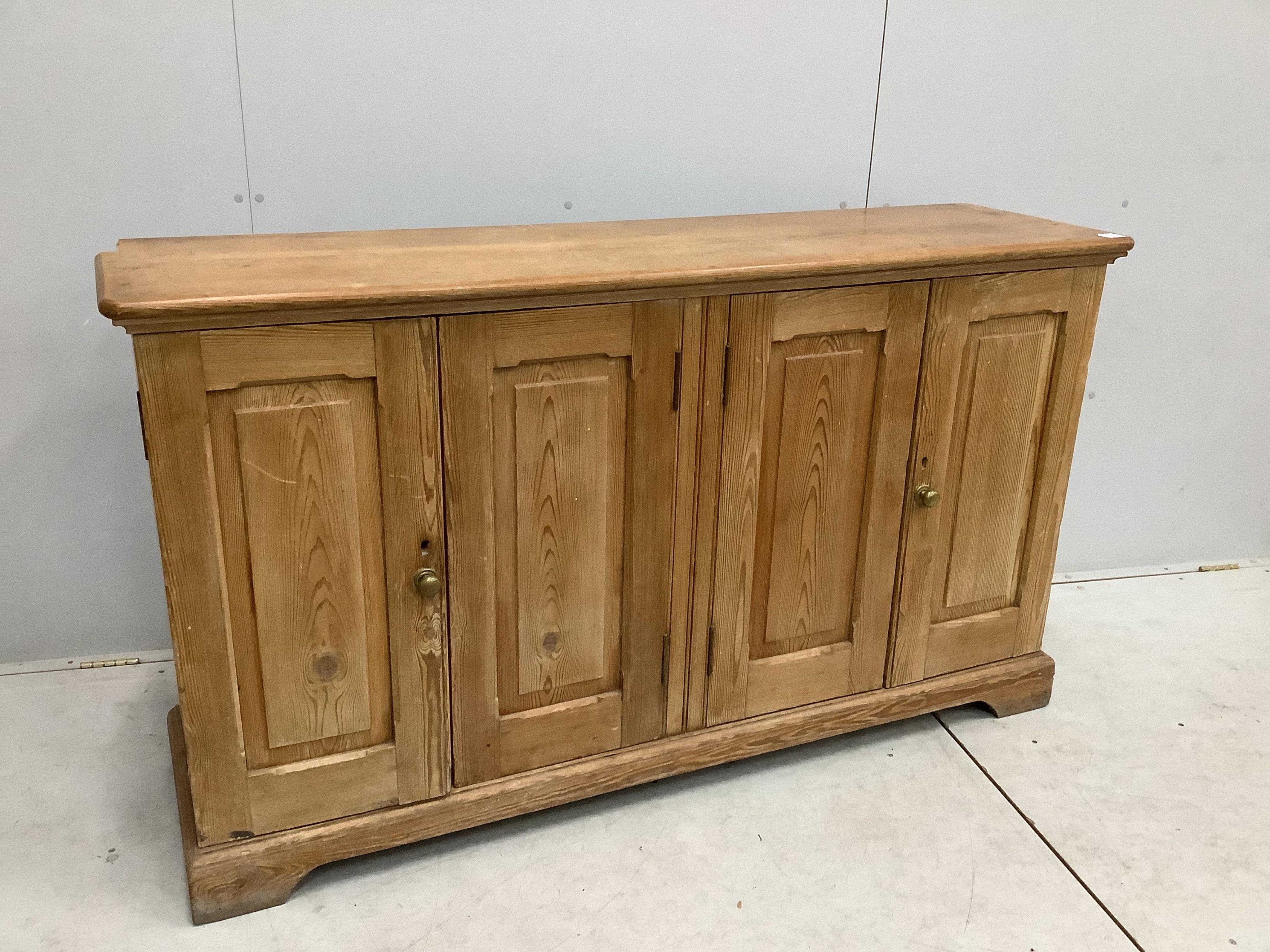 A late Victorian pitch pine four door side cabinet, width 158cm, depth 42cm, height 91cm. Condition - fair